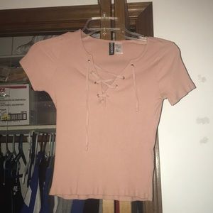pink lace up short sleeve shirt.